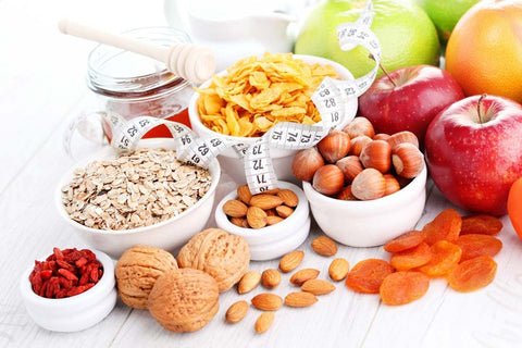 Cereals, fruit and nuts beside a measuring tape