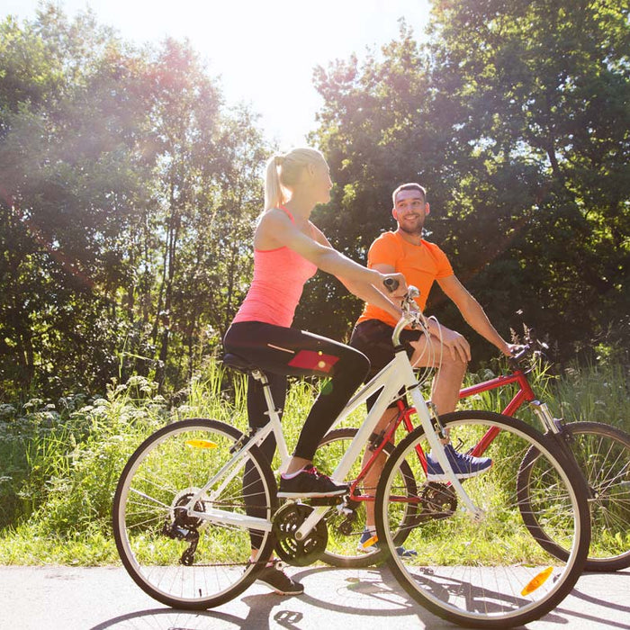 Cyclists riding on a sunny path