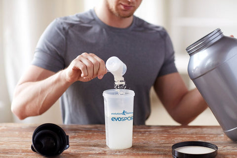 Man mixing protein powder in a shaker