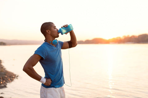 Man drinking water after an outdoor run