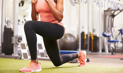 Woman performing a lunge in a gym
