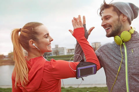 Two runners high-fiving after an outdoor workout