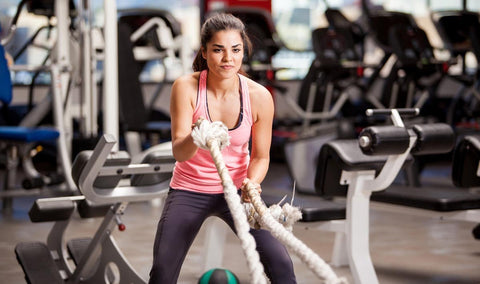 Woman exercising with dumbbells in a gym