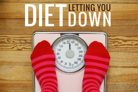Feet on bathroom scales beside diet advice