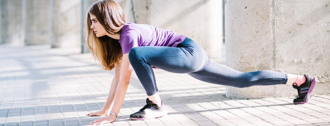 Woman stretching outdoors before a workout