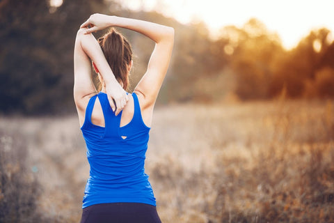Woman stretching her back outdoors after exercise