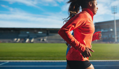 Woman running on an athletics track